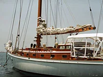 Classic wooden sailboat with bright finish