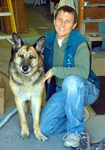 Judy Fenner with her dog in the shop