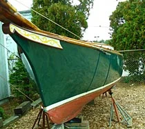 Green wooden hull on stands