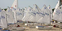 Optimist dinghies lined up on shore